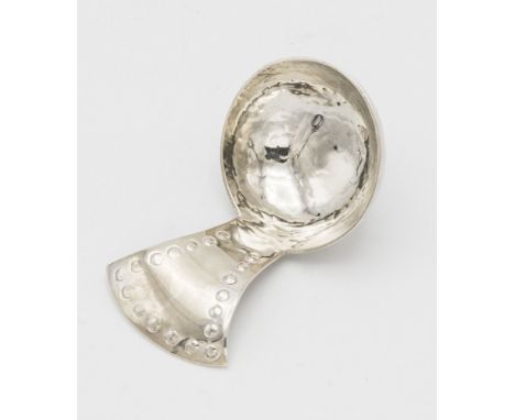 An Edwardian Arts & Crafts style silver caddy spoon by the Keswick School of Industrial Art, Chester 1907, of planished form,