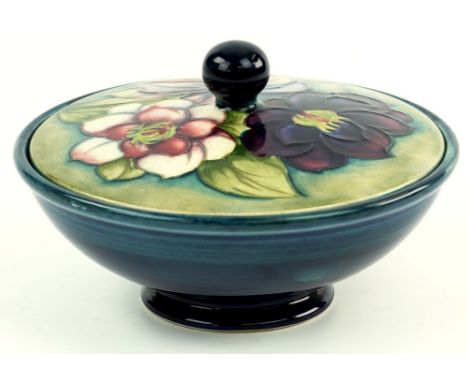 A Moorcroft covered bowl, post war, Clematis pattern to cover with ball finial, on plain shaded blue base, impressed factory 