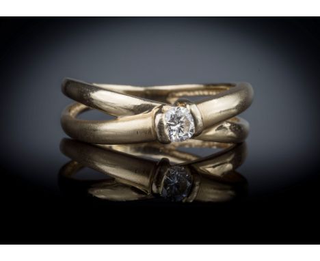 A 14ct yellow gold and diamond solitaire ring, the single brilliant cut diamond, approx. 0.20ct, on a pierced cross over shan