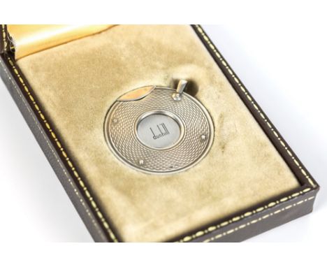 A cased Dunhill silver cigar cutter, 1970s-80s, circular form, engine turned decoration, with hanging loop, stainless steel b