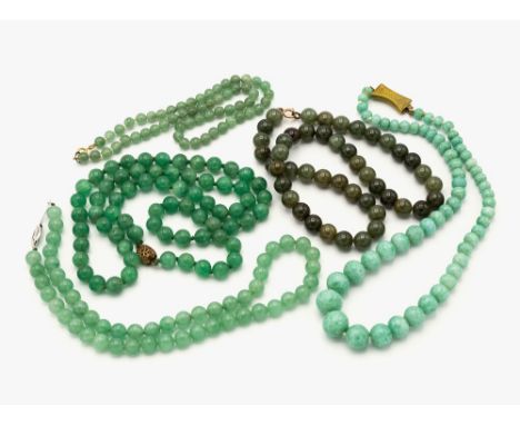A collection of five Oriental jade necklaces, three with round jade beads, one spinach jade example, one of graduated form wi