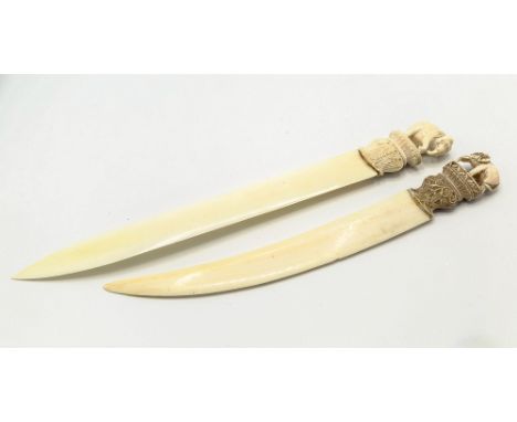 Two 19th century Indian carved ivory paper knives, one with double straight back blade convex blade with foliate carved bolst