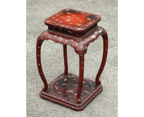 A Ryukyuan island carved wooden stand, early 19th century, red lacquer with burnished augmentation, mother of pearl flower an