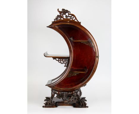 A Chinese carved hardwood table top display cabinet, early 20th century, in the form of a crescent moon, with side hinged bev