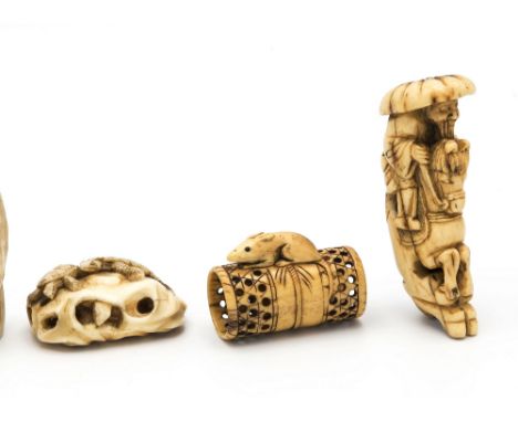 A Japanese carved ivory netsuke, Meiji period (1868-1912), depicting turtles climbing upon and inside a pierced rock, 2½in. (