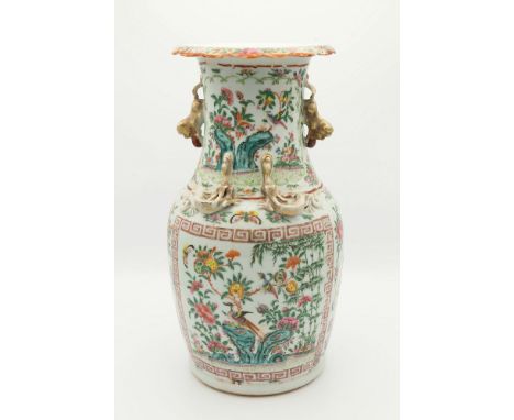 An early 19th century Chinese Canton famille rose vase, ovoid form with everted scalloped rim, twin gilt Buddhistic lion hand