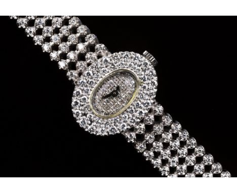 A ladies 14ct white gold and diamond manual wind cocktail watch, the movement by Juvenia MFG, no. 1055, the oval 12 x 7mm. di