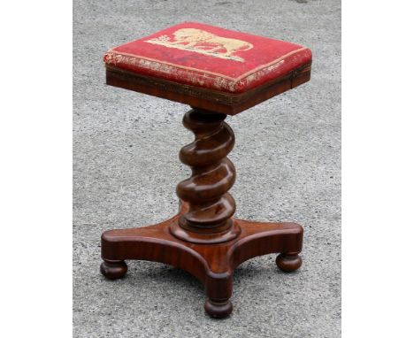 A mid-19th century mahogany adjustable piano stool, the square, over stuffed seat in petit point embroidery depicting a lion,