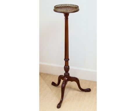 A mahogany candle stand, circa 1900, circular top plate with pierced gilt gallery on lightly flared column with carved bead w