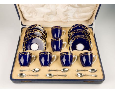 A cased Royal Worcester porcelain coffee set with silver spoons, puce factory marks with date code for 1936, six cups and sau