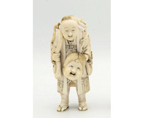 A Japanese carved ivory okimono of a toy seller, Meiji period (1868-1912), finely carved, the man with a sinuous root stick o