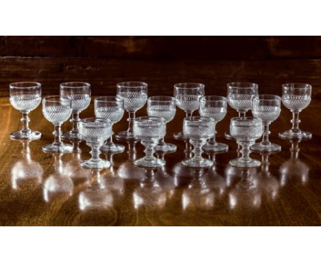 A set of six Georgian small wine glasses, the cup bowls with lower diamond and step cutting, on a flattened knopped stem and 