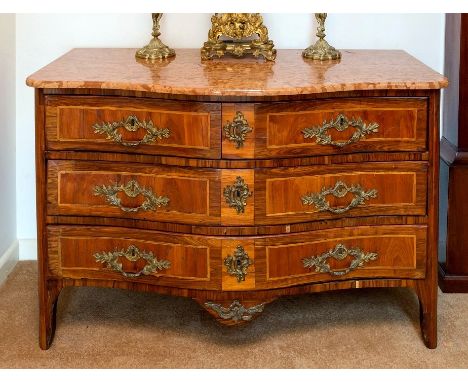 An early 19th century French serpentine fronted commode, of two short over two long drawers, the Alba Rosa marble top over an