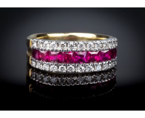 An 18ct yellow gold, ruby and diamond ring, set with a row of graduated French cut rubies within borders of brilliant cut dia