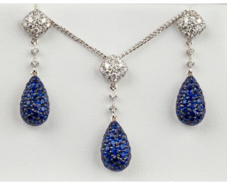 An 18ct white gold, sapphire and diamond cluster pendant with matching earrings en suite, the pendant and earrings each of te