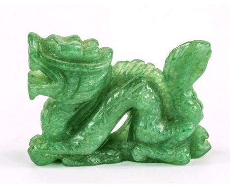 A Chinese carved green jade miniature dragon, 20th century, 2¼in. (5.7cm.) long.