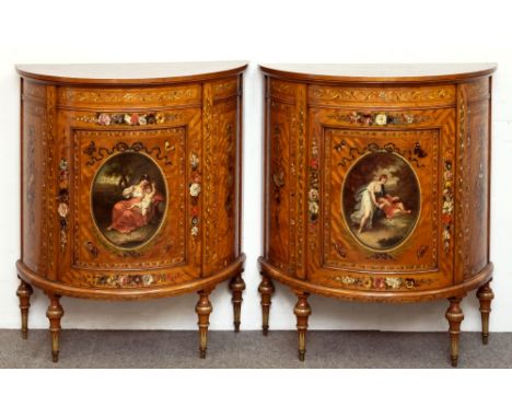 A fine pair of late 19th century painted satinwood demi-lune commodes, the top surfaces decorated with Adams style floral gar