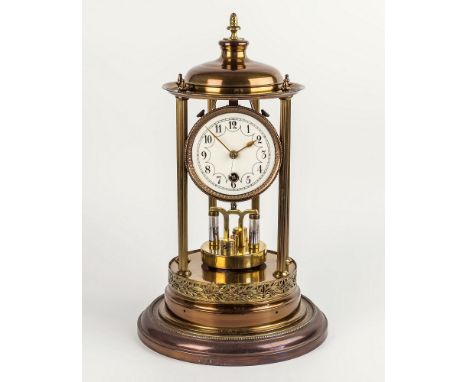 A late 19th Century brass 'bandstand' anniversary clock, the domed top with central pine cone finial, supported by six slende