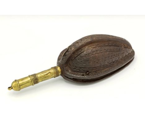 An Omani Abu Faithiler carved wooden powder flask, 18th century, ovoid form, flat top cover over carved bowl with circle engr