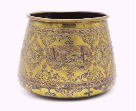 A Mamluk brass and silver inlay revival basin, circa 1880, cylindrical form flaring to convex base, raised decoration of thul