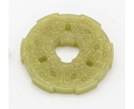 A Chinese pale celadon jade bi-disc, possibly Ming / early Qing period, the disc of circular form with slightly dentilated ri