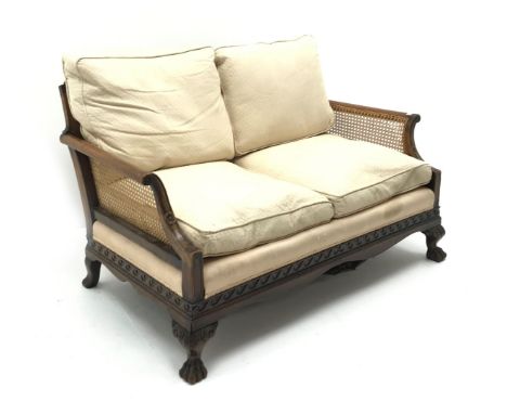 Early 20th century walnut two seat Bergere sofa, scrolled arms, acanthus carved cabriole leg with hairy paw feet, W134cm Cond