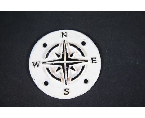 Circular cast iron compass points sign, D: 9 cm. P&amp;P Group 1 (£14+VAT for the first lot and £1+VAT for subsequent lots) 