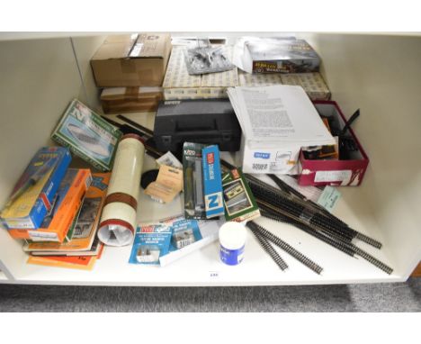 A shelf of N gauge Accessories and Track including Peco, Arnold Kits, many pieces of track etc
