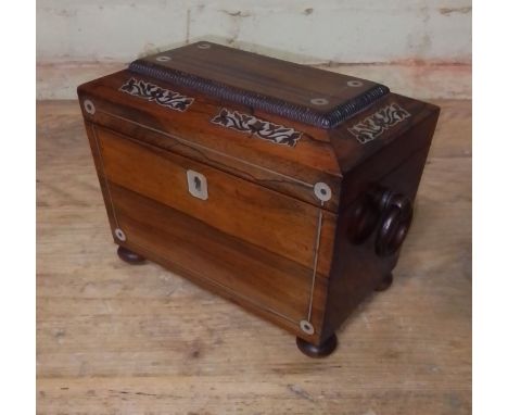 A Regency mother of pearl inlaid rosewood tea caddy of sarcophagus form, length 21.5cm.  