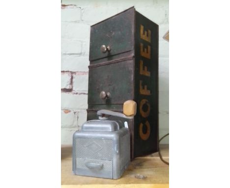 A vintage Moulux coffee grinder with a vintage tin coffee chest.  