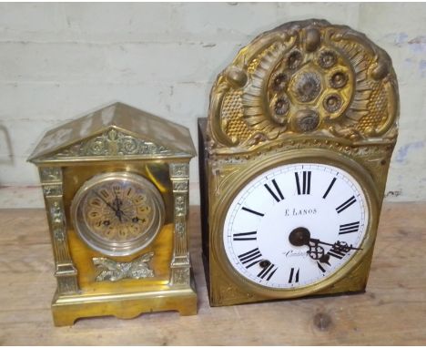 An architectural brass mantel clock and a French comtoise clock.  