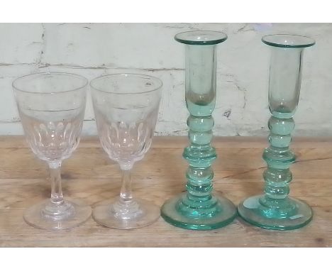 A pair of late 19th century bobbin glass candlesticks, height 22cm and a pair of cut glass stem ale glasses, height 17cm.  