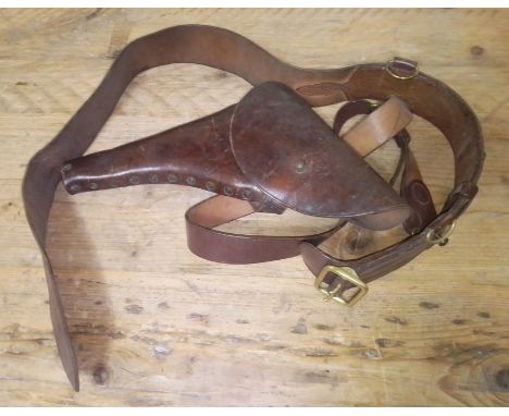 A WW1 British military belt with shoulder strap and pistol holster, marked AS Dawson &amp; Son LD, 1916 together with a swagg