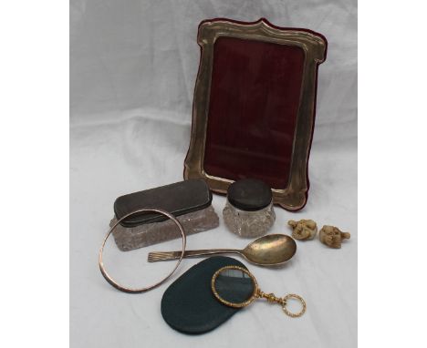 An Elizabeth II silver photograph frame, Birmingham, 1994 together with a silver spoon, a silver bangle, silver topped dressi