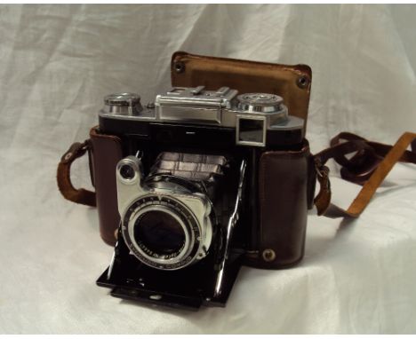 A Zeiss Super Ikonta 533/16 camera, in a removable brown leather case