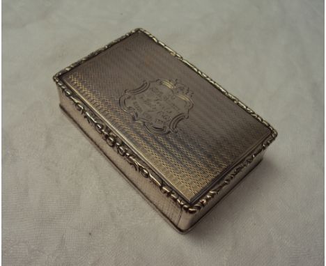 A Victorian silver snuff box of rectangular form with a leaf moulded border and engine turned decoration with a cartouche to 