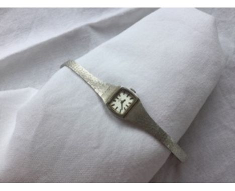 A lady's 9ct white gold Rotary wristwatch with a rectangular dial and batons, on a textured 9ct white gold strap strap, overa
