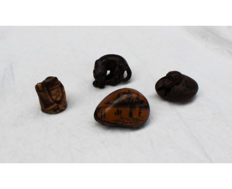 A Japanese hardwood netsuke in the form of a prowling tiger, 42mm wide x 30mm high together with a netsuke in the form of a n