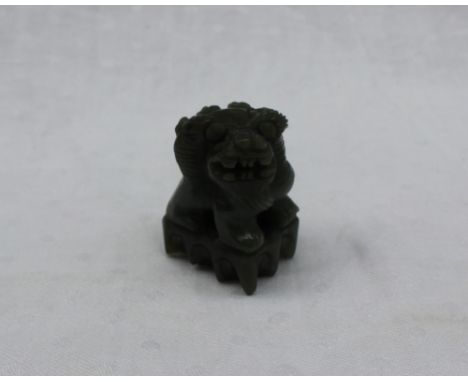 A green jade model of a Dog of Foo, in dark green, 47mm high 