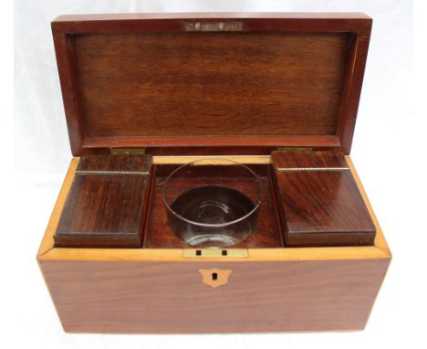 A 19th century mahogany tea caddy, of rectangular form with a shield inlay, enclosing two lidded compartments and a central g