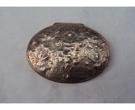 A continental white metal snuff box of oval form, the lid decorated with a central figure, leaves and horns, 72mm wide, appro