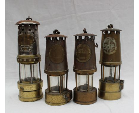 A Thomas & Williams steel and brass miners lamp, together with three Protector Lamp & Lighting Co Ltd miners lamps