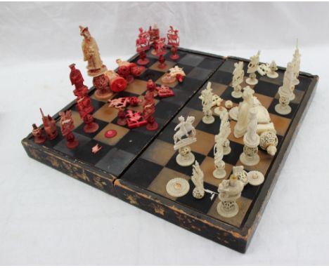 A 19th century Chinese puzzle ball part chess set, half stained red together with a lacquered folding chess board, a wooden c