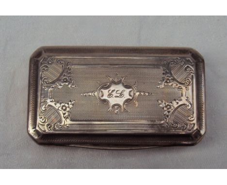 A French white metal snuff box of rectangular form, decorated with scrolls and flowers with engine turned decoration, 8cm wid