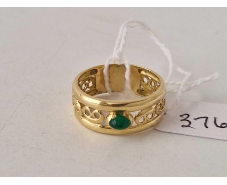 A pieced band ring set with a central cabochon emerald 18ct gold size O 4.5 gms