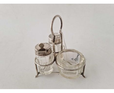 A small three piece cruet on wire decorated stand with ring handle, 4 inches high, Birmingham 1909