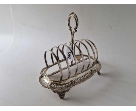 A good Victorian shaped oval toast rack with pierced decoration, ring handle, 7.5 inches wide, Sheffield 1869 by HW? 330 g.