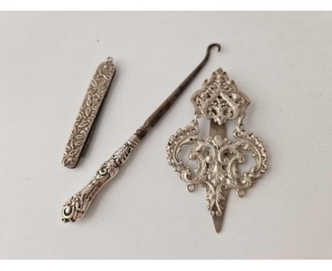 A chatelaine clasp, a pen knife and a button hook with silver handle