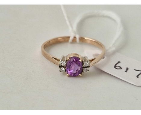 A gold mounted single stone purple sapphire ring with diamond set shoulders size T 2.2 gmd
