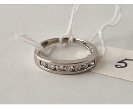 A platinum half eternity ring with seven diamonds size J 2.7 gms